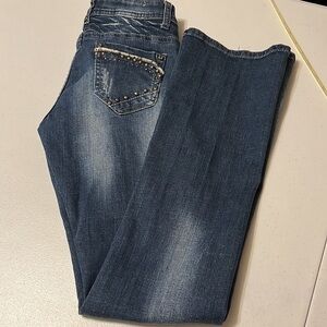 Liuce’s distressed jeans with metal embellishment. Size 5